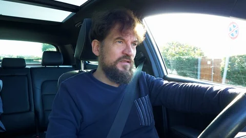 Tired man yawning while driving car Stock Footage 115799113