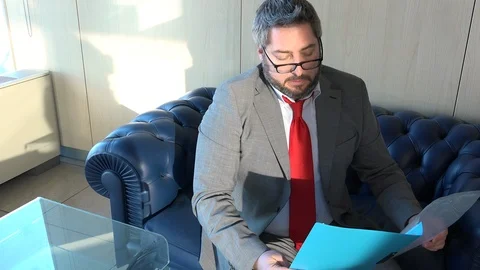 Tired manager stop reading data analytics in office, falling asleep on the sofa Vídeo Stock 102116661