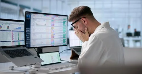 Tired Medical Coder Struggles Managing Hospital Billing Codes Late Night. Stock Photos