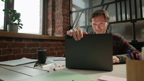 Tired Middle-Aged Male Programmer Opening Laptop at Workplace Video stock 319997278
