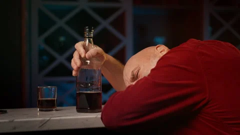Tired middle-aged man asleep at bar counter after job loss and bankruptcy Stock Footage 346714122