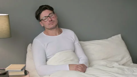Tired Middle Aged Man taking Nap in Bed Stock Footage 142366838