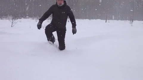 Tired middle aged man walks in snow shoes in forest covered fresh snow Stock Footage 231252530