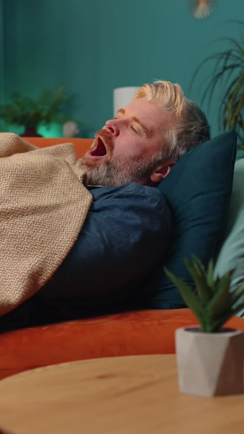 Tired middle-aged mature man lying down in bed taking a rest at home, napping Stock Footage 347055525
