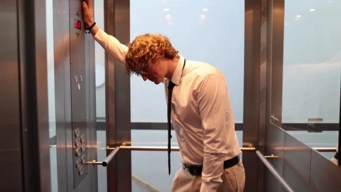 Tired office worker rides elevator to work Stock Footage 333969134