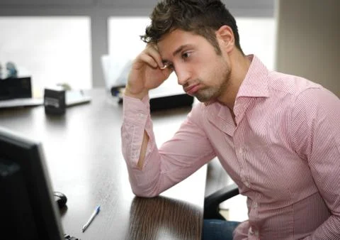 Tired or frustrated office worker looking at computer screen Stock Photos