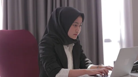 Tired overwhelmed young asian business woman in the office working on laptop Stock Footage