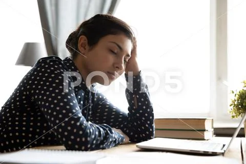 Tired overworked millennial hindu woman sleeping resting. Stock Photos
