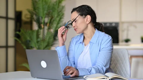 Tired, overworked sad mixed race mature woman wearing glasses, freelance Stock Footage 152518696