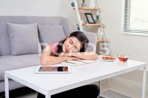 Tired overworked woman resting while she was working writing notes Stock Photos