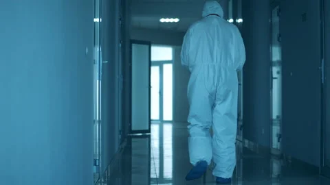 Tired paramedic sits down on the floor in the hospital hall Stockbeeldmateriaal 130642376