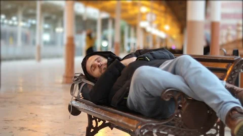 Tired passenger sleeping at the train station Stock Footage 101205319
