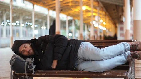 Tired passenger sleeping at the train station Stock Footage 101233735