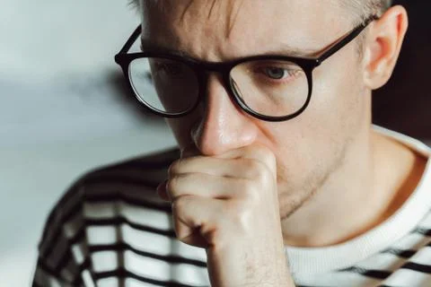 Tired pensive man deeply thinking at home. Winter depression. Seasonal affect Stock Photos