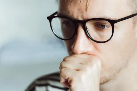 Tired pensive man deeply thinking at home. Winter depression. Seasonal affect Foto stock