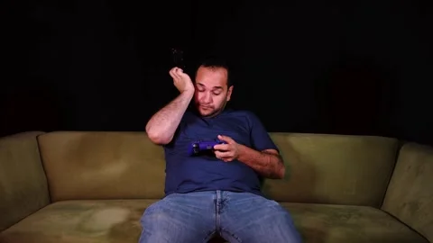 Tired player playing game Stock Footage 255611385