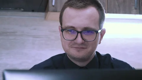 Tired programmer in big glasses smiling Stock Footage 201612722