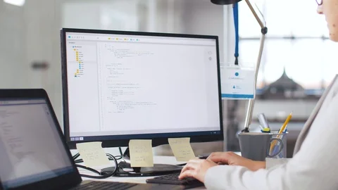 Tired programmer with computer working at office Stock Footage 105029453