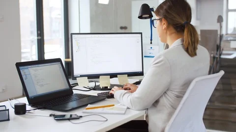 Tired programmer with computer working at office Stock Footage 105418292