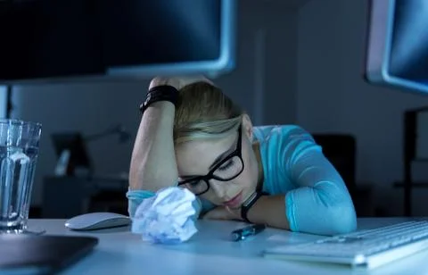 Tired programmer feeling exhausted in the office Stock Photos