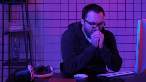 Tired programmer looking at some process on the computer. Foto stock