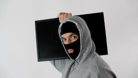 Tired programmer or hacker works at home in quarantine at night. Stock Photos