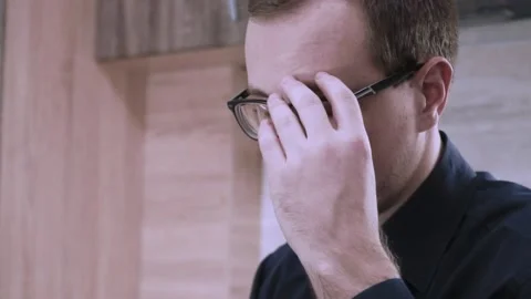 Tired programmer rubs his eyes. concept of home office Stock Footage 201612942
