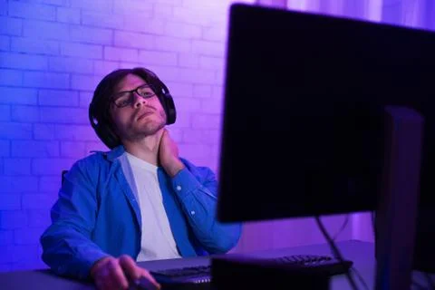 Tired Programmer Working On Computer Touching Aching Neck At Home Foto stock