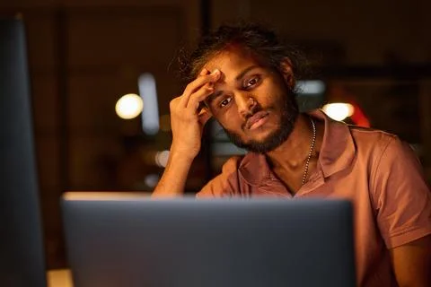 Tired programmer working over new program Stock Photos