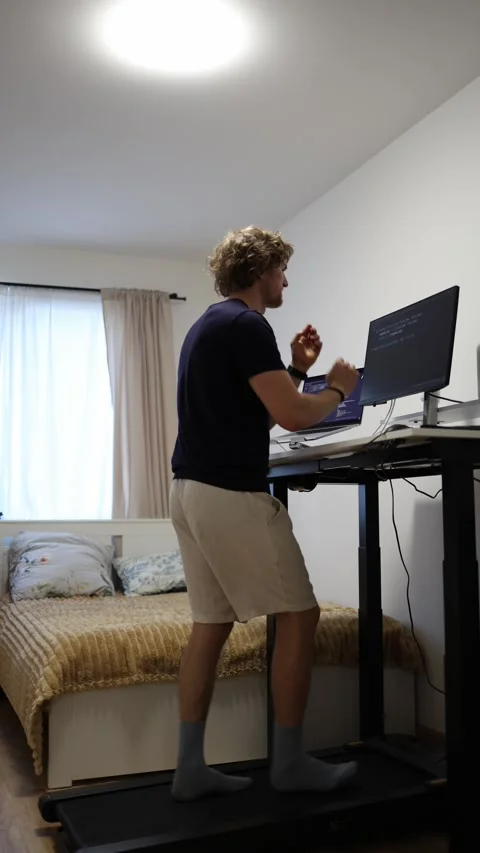 Tired remote worker checks time waiting for his workday to finally end Stock Footage 346881247