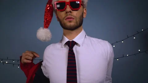 Tired Santa puts on his jacket and takes off his glasses Stock Footage 167652614