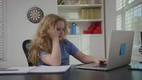 Tired school student learning in home interior. Tired school child facing study Stock Footage 345542973