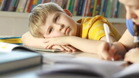 Tired schoolboy sleeping in classroom at school. Elementary school student slee Stock Footage 87611567
