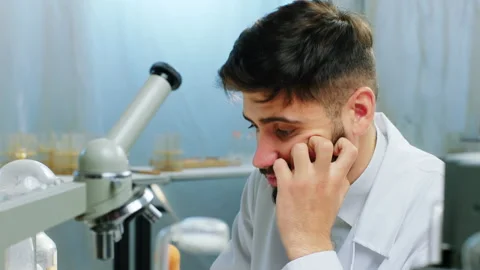 Tired scientist student try to end his college project on the chemistry Stock Footage 153083875