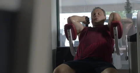 Tired senior man training on exercise machine Video stock 62962846