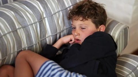 Tired sleepy young boy lying on couch wa... | Stock Video | Pond5