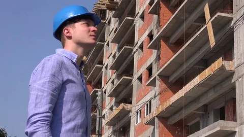 Tired stressed builder contractor worker putting away helmet hardhat at site 4K Stock Footage