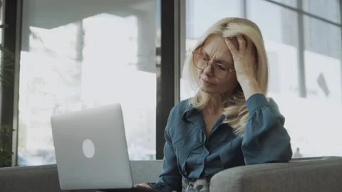 Tired stressed upset middle aged mature woman feeling sick headache after Video stock 147740439