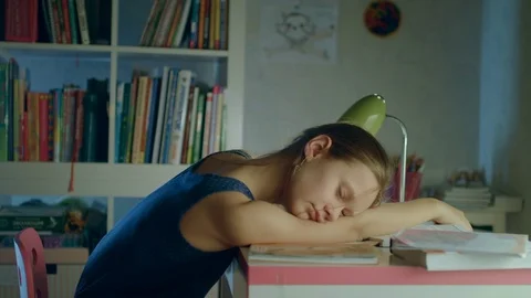 A tired student doing homework till night Stock Footage 82421260