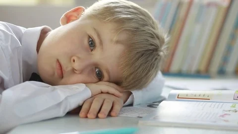 Tired student elementary school does lessons.  Stock Footage 73445373