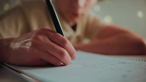 Tired student trying to do homework at night, lacking motivation. Stock Footage 336388624