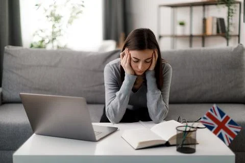 Tired student using laptop Foto stock