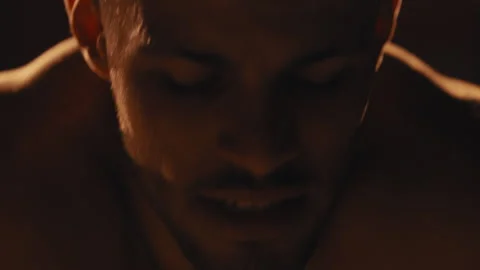 Tired sweating fighter in a dark room Stock Footage 275083940