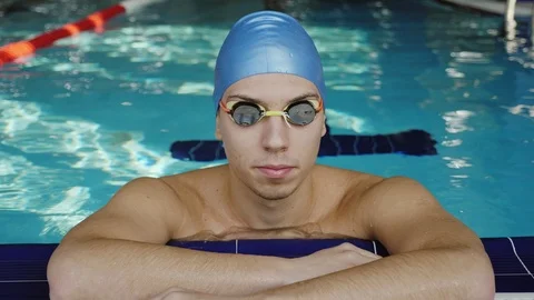 The tired swimmer rests in the pool Stock Footage 97197693