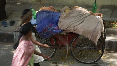 Tired-vegetable-vendor-sleeping-sidewalk Stock Footage 128793746