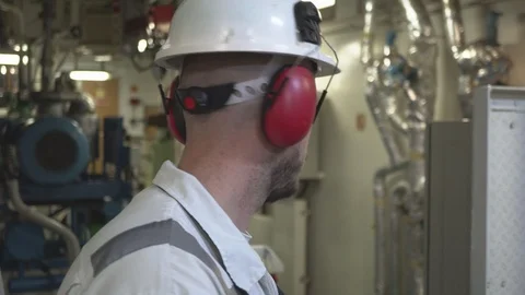 Tired vessel engineer with beard wearing white helmet Stock Footage 117588972