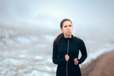 Tired Winter Runner Jogging Outside on Cold Weather Stock Photos