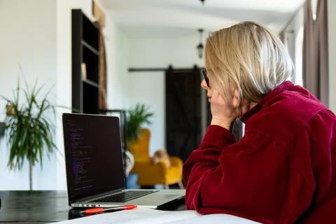Tired woman developer working with computer at home office Stock Photos