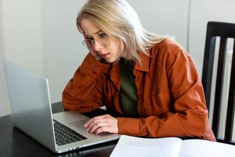 Tired woman developer working with computer at home office 스톡 사진