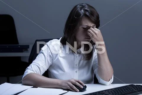 Tired woman using computer Stock Photos
